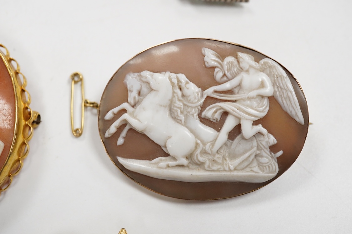 A collection of jewels, comprising: an Art Deco green and colourless paste jabot pin; two shell cameo brooches, depicting a lady in profile, length 4.7cm, stamped 9ct, and Sol's chariot respectively; and a gilt metal and